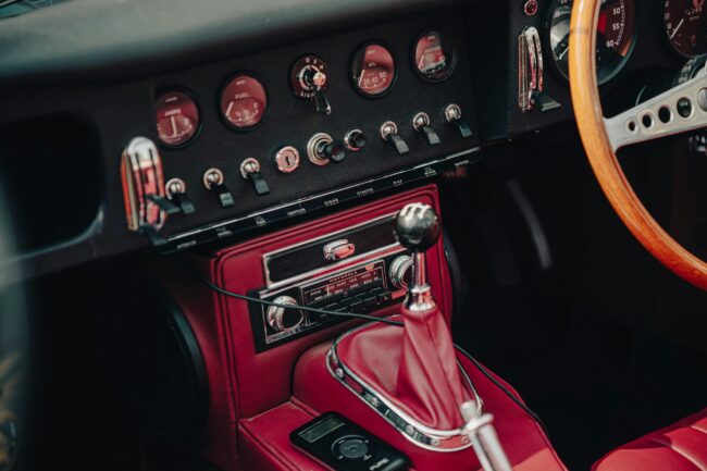 Vintage car dashboard with red leather interior