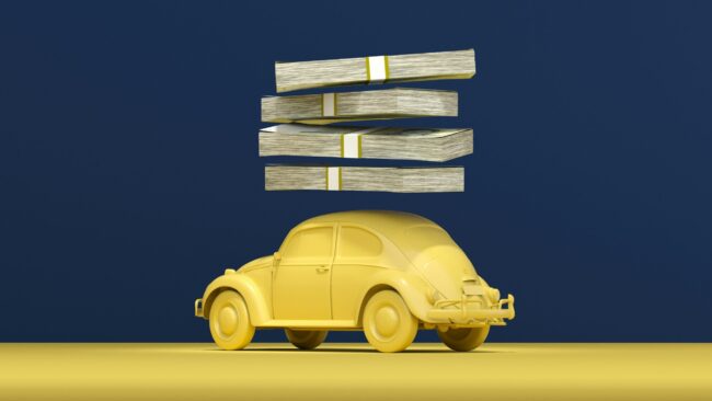a yellow car with stacks of money on top